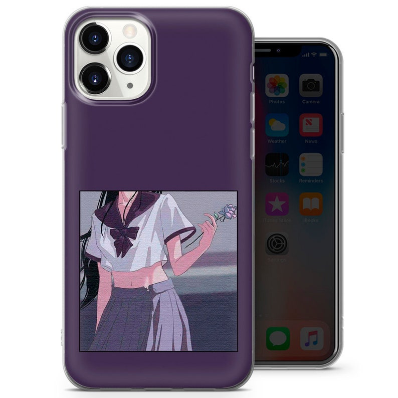 May include: A clear phone case with a purple background and a graphic of an anime girl in a school uniform holding a flower. The girl has long black hair and is wearing a white shirt with a blue bow tie and a purple skirt.