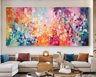 May include: Abstract painting with a colorful, textured design. The painting features a variety of colors, including pink, orange, yellow, blue, and green. The painting is framed in a gold frame.