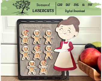 May include: A wooden cutout of a woman holding a plate with the text "Grandma's Cookies" above. There are eight gingerbread people cutouts with names written on them, including Janet, Jack, Oliver, Melissa, Justin, Matthew, and Sarah.
