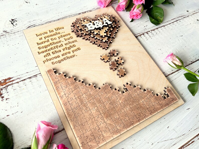 May include: A wooden heart-shaped puzzle with the letters "B&A" in the center. The puzzle is surrounded by a quote about love being like a puzzle. The quote reads: "Love is like a puzzle... hard to piece together, but beautiful when all the right pieces are put together."