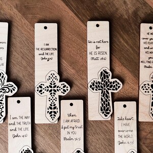 May include: Set of ten wooden bookmarks with a cross design and inspirational bible verses. Each bookmark features a different verse and a cross with a floral pattern.