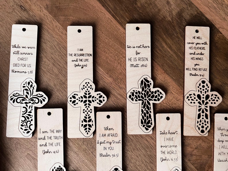 May include: Set of ten wooden bookmarks with a cross design and inspirational bible verses. Each bookmark features a different verse and a cross with a floral pattern.