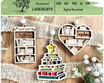 May include: Three wooden Christmas ornaments with a book theme. The first ornament is a bookshelf with the name "Matthew" on it. The second ornament is a heart-shaped bookshelf with the name "Sophia" on it. The third ornament is a stack of books shaped like a Christmas tree with the name "Hark" on top.