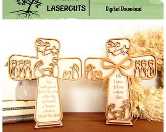 May include: Two wooden cross-shaped laser-cut decorations. Each cross features a nativity scene with figures and text. One reads "For unto you is born this day..." and the other "Oh Come Let us adore Him." The top banner reads "Treasured Lasercuts".