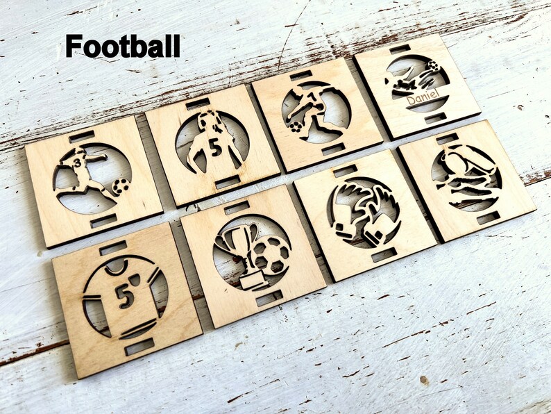 May include: Eight wooden squares with laser cut designs of football players, a trophy, a jersey, and a ball. The word "Football" is written at the top of the image.