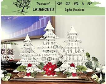 May include: Three white wooden Christmas trees decorated with sheet music, holly, berries, and a red poinsettia. The trees are on a wooden base.