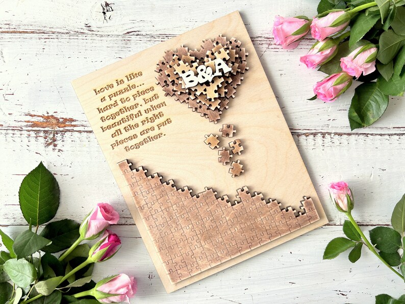 May include: A wooden heart-shaped puzzle with the letters "B&A" in the center. The puzzle is surrounded by a quote about love being like a puzzle. The quote reads: "Love is like a puzzle... hard to piece together, but beautiful when all the right pieces are put together."
