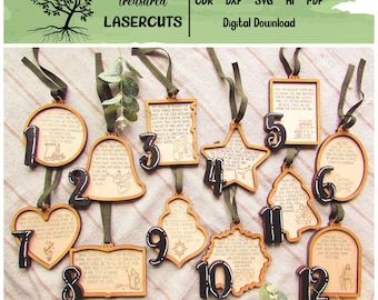 May include: Wooden Christmas ornaments with numbers 1-12, each with a unique shape and design. The ornaments have a natural wood finish with black numbers and green ribbon hangers. The text "Treasured Lasercuts" is at the top.