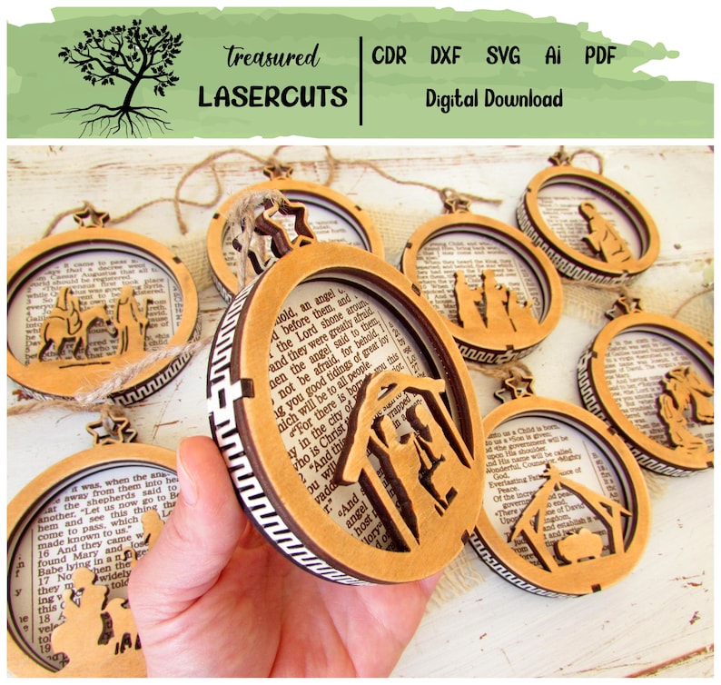 May include: Wooden Christmas ornaments with laser-cut Nativity scenes and biblical text backgrounds. The ornaments are circular with a brown frame and a white and brown patterned edge. The text "Treasured Lasercuts" is at the top.