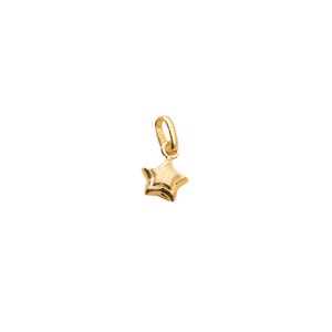 May include: A small gold star charm pendant. The star has a slightly raised design and is attached to a small loop.