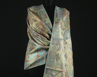 May include: A green, blue, and gold paisley patterned scarf with a fringed edge.