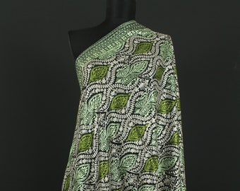 May include: A black shawl with a green and white paisley pattern. The shawl is embroidered with a delicate floral design.