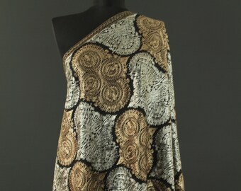 May include: A black shawl with a gold and silver paisley pattern. The shawl is draped over a mannequin.