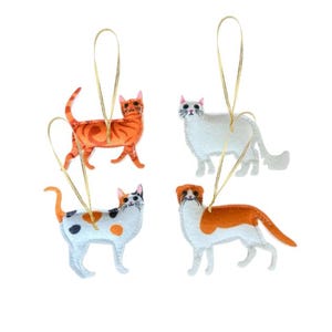 May include: Four felt cat ornaments with gold string hangers. The cats are white, orange and white, calico, and orange and white.