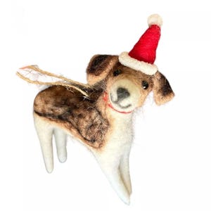 May include: A brown and white felt dog ornament wearing a red Santa hat. The ornament has a string loop for hanging.