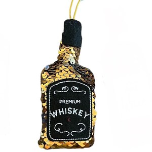 May include: Gold sequin whiskey bottle ornament with a black label that reads "Premium Whiskey".