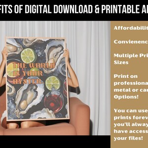 May include: A framed art print featuring the phrase "The World Is Your Oyster" with illustrations of oysters, limes, and cocktails. The image is held by a person sitting on a sofa. Text on the right side lists the benefits of digital downloads.
