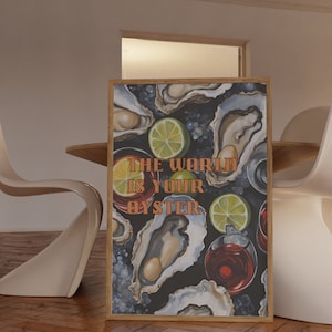 May include: A framed art print featuring a dark background with illustrations of oysters, lime slices, and glasses of red liquid. The text "THE WORLD IS YOUR OYSTER" is displayed in orange letters.