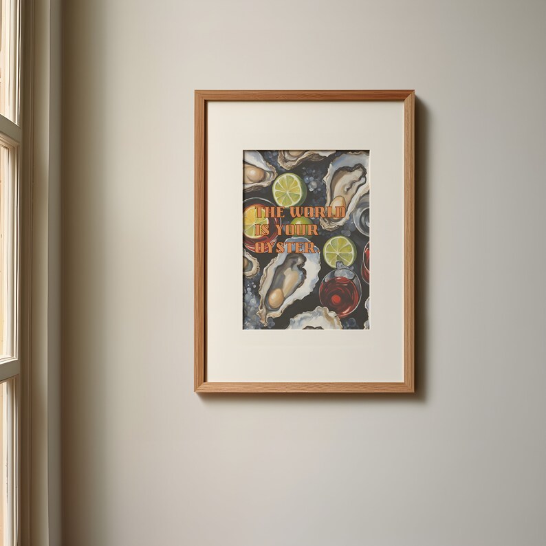 May include: Framed art print featuring an oyster and cocktail illustration. The artwork includes oysters, lime slices, and drinks, with the text "The World Is Your Oyster" in orange. The print is set in a light brown wooden frame.