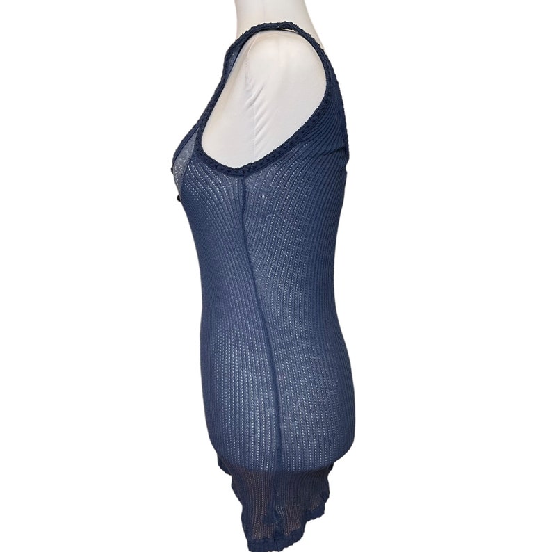 May include: A navy blue sleeveless top with a delicate lace trim around the neckline and hem. The top is made of a lightweight, breathable fabric and has a fitted silhouette.