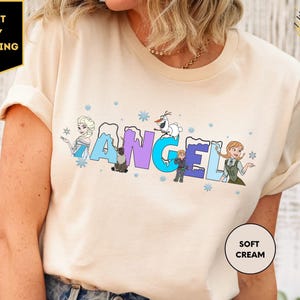 a woman wearing a t - shirt with the word angel printed on it