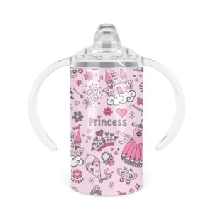 May include: Pink stainless steel sippy cup with a clear lid and two handles. The cup features a princess-themed design with a castle, crown, wand, and dress. The text "Princess" is printed on the cup.