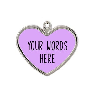 May include: A silver heart-shaped charm with a light purple background and the text "YOUR WORDS HERE" in black.