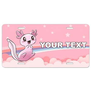 May include: Pink and white personalized license plate featuring a cartoon axolotl with a rainbow and clouds. The text "YOUR TEXT" is printed on the plate.