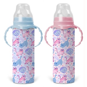 May include: Two baby bottles with handles and a cat print design. One bottle is blue with pink cats and the other is pink with blue cats.