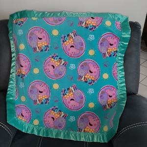 Peppa Pig, Infant Receiving Crib Fleece blanket with a light green or turquoise satin edging