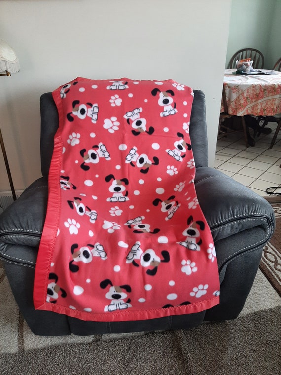 Black and White Puppies on Salmon colored background Pet Toddler Fleece Blanket with a salmon colored satin trim