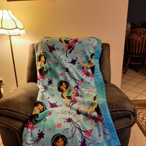 Jasmine, Kids Fleece Blanket with light bright blue satin trim.