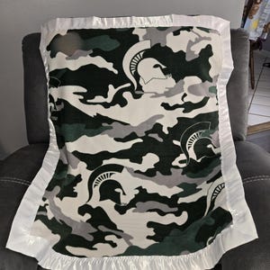 Michigan State University Camouflage, Infant Crib Fleece Blanket with a matching white satin trim