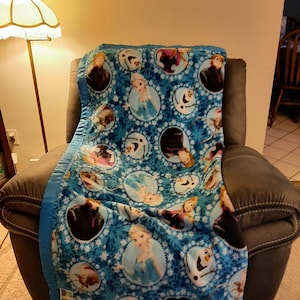 Frozen Elsa, Anna, Olaf and Kristoff, Kids Fleece Blanket with bright blue satin trim.