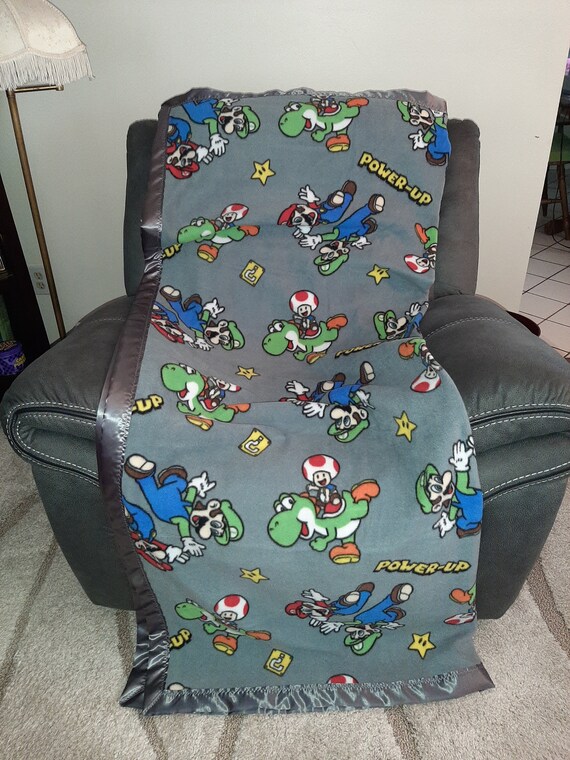 Mario Luigi Toad and Yoshi Big Tall Fleece Blanket with a dark gray satin trim