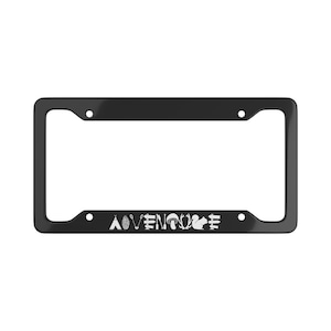 May include: A black rectangular license plate frame featuring a white graphic design at the bottom. The design includes a teepee, pinecone, arrows, mushroom, antlers, squirrel, and signposts, with the word ADVENTURE spelled out in white.