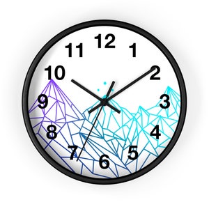 May include: A white clock face with black numbers and hands. The clock face has a geometric mountain design with blue and purple gradients. The clock has a black frame.