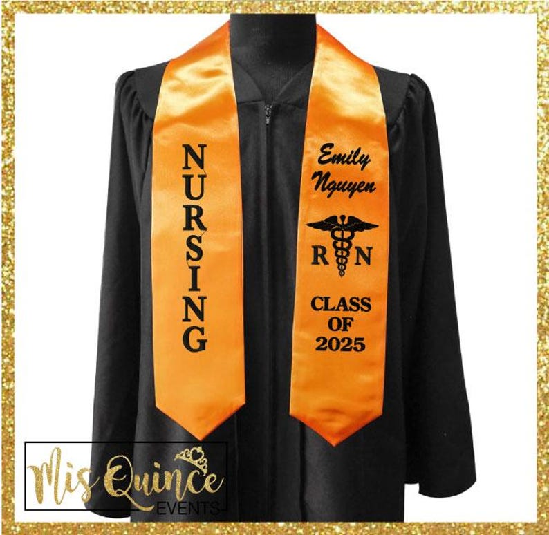May include: Black graduation gown with an orange nursing sash. The sash has the word "NURSING" vertically printed on one side and the name "Emily Nguyen", the Registered Nurse symbol, and "CLASS OF 2025" on the other.