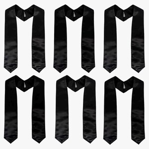 May include: Six black graduation stoles with a satin finish are displayed against a white backdrop. Each stole features a V-neck design and a pointed end. The stoles are arranged symmetrically, creating a balanced visual.