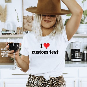 May include: White t-shirt with a red heart and the text "I ♥ custom text" printed on the front.