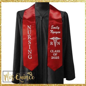 May include: Black graduation gown with a red satin sash. The sash is embroidered with the word "NURSING" in white, the name "Emily Nguyen", a caduceus symbol, the letters "RN", and "CLASS OF 2025". The image is framed with a gold glitter border.
