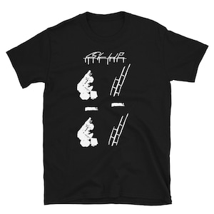 May include: Black t-shirt with white graphic print of two ladders and two figures. The text "By the" is printed above the graphic.