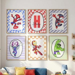 May include: Six framed wall art prints featuring cartoon superheroes including Spider-Man, Iron Man, and Hulk. One print displays a large red letter H with the name Henry written in black script. Each print has a unique coloured checkered or striped background.