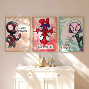May include: Three framed superhero art prints. The prints feature Spider-Man characters with the phrases "I AM BRAVE", "I AM POLITE", and "I AM LOVED". The artwork has a cartoon style with vibrant colors and bold outlines.