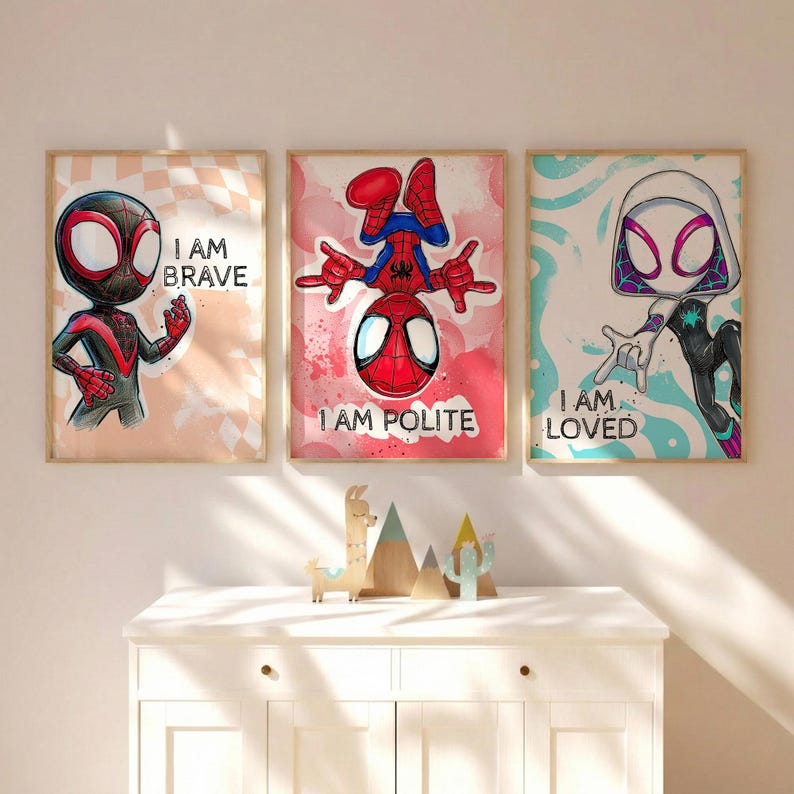 May include: Three framed superhero art prints. The prints feature Spider-Man characters with the phrases "I AM BRAVE", "I AM POLITE", and "I AM LOVED". The artwork has a cartoon style with vibrant colors and bold outlines.
