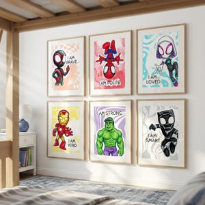 May include: Six framed art prints featuring superhero characters. Each print has a cartoon illustration of a character with a positive affirmation. The characters include Spider-Man, Iron Man, and Hulk. The prints are in a child's bedroom.