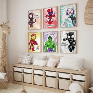 May include: Six framed superhero art prints with the phrases "I AM BRAVE", "I AM POLITE", "I AM LOVED", "I AM KIND", "I AM STRONG", and "I AM SMART". The prints are displayed above a wooden storage unit with white bins.