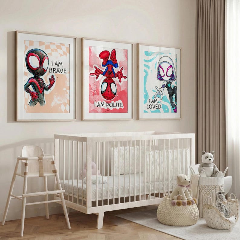 May include: Three framed art prints featuring Spider-Man characters. The prints display the phrases "I AM BRAVE", "I AM POLITE", and "I AM LOVED". The artwork is set against a nursery backdrop with a white crib and high chair.