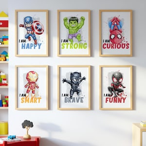 May include: Six framed art prints featuring superhero characters. Each print has a cartoon illustration of a superhero with the words "I AM" followed by an adjective: Happy, Strong, Curious, Smart, Brave, and Funny. The frames are light brown.