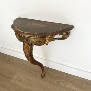 Elegant antique wall console table in carved and gilded wood, Rococo style, with patinated half-moon top